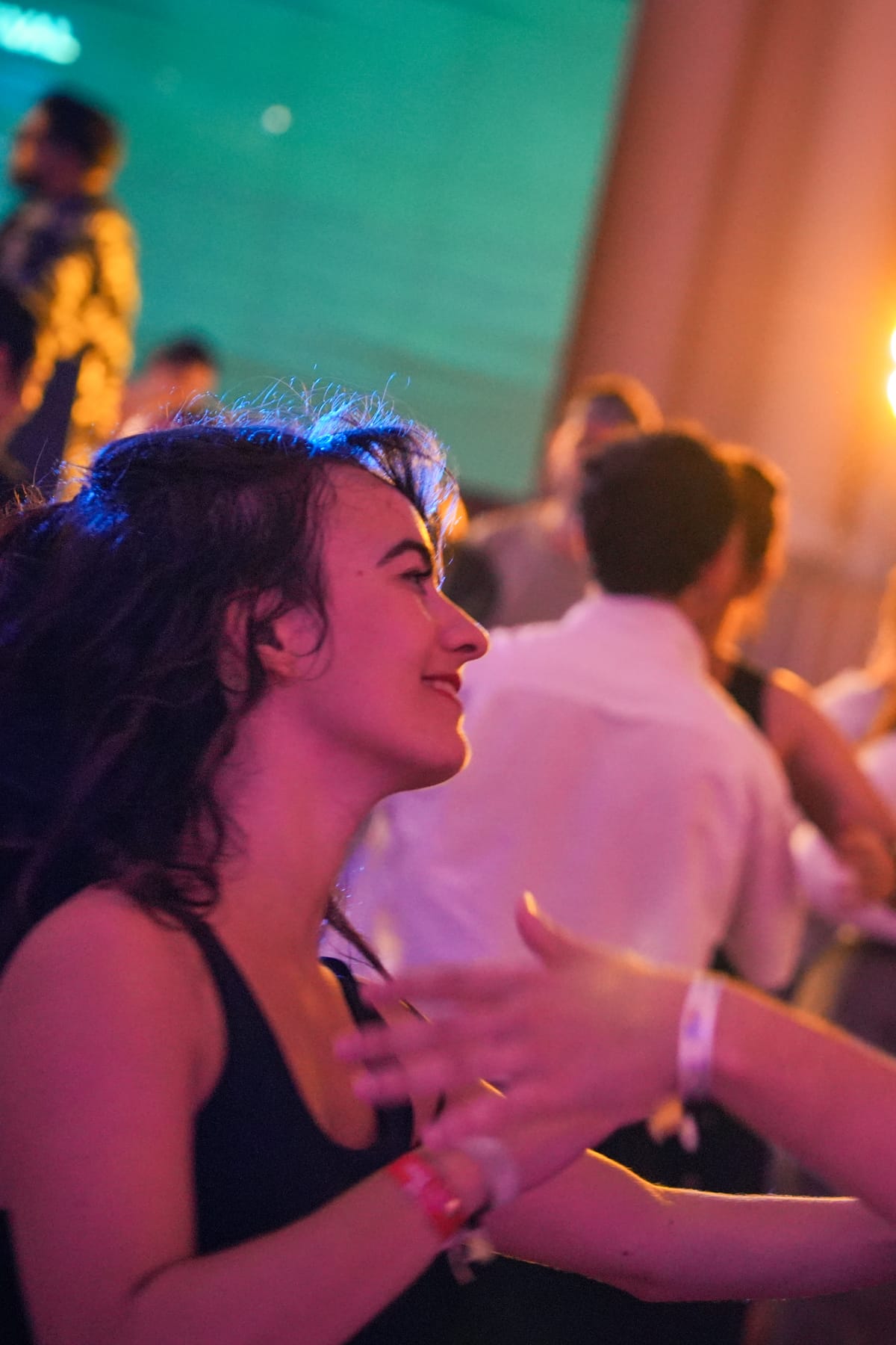 The crowd dancing under chandeliers at a live concert